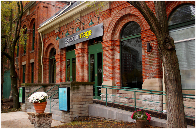 entrance of a red brick building with a sign