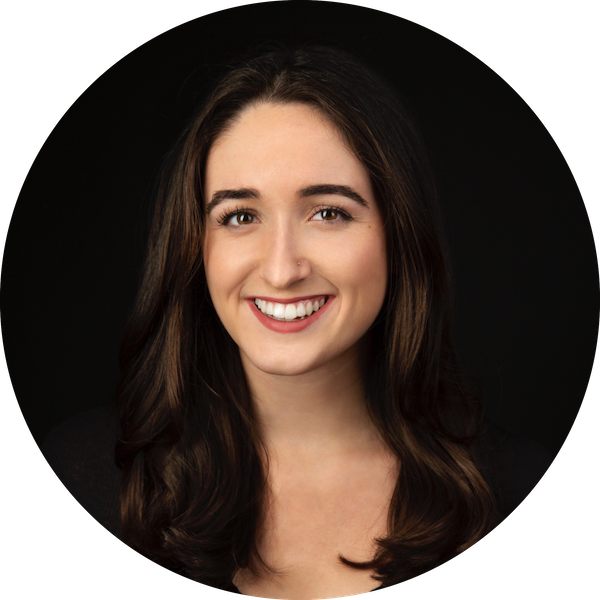 Headshot of Kiera, smiling, she is a woman with brown hair and eyes. 